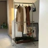 The coat is hung on the clothes hanger overnight in the living room